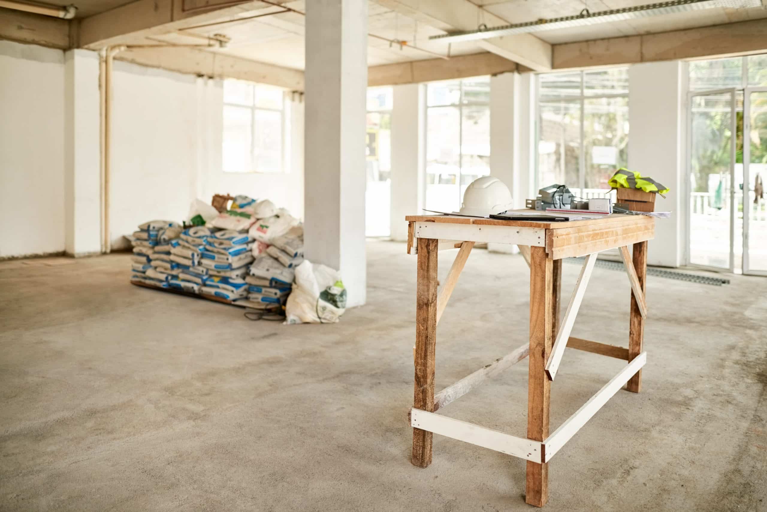 Shot of a new construction site with a workbench and cement bags